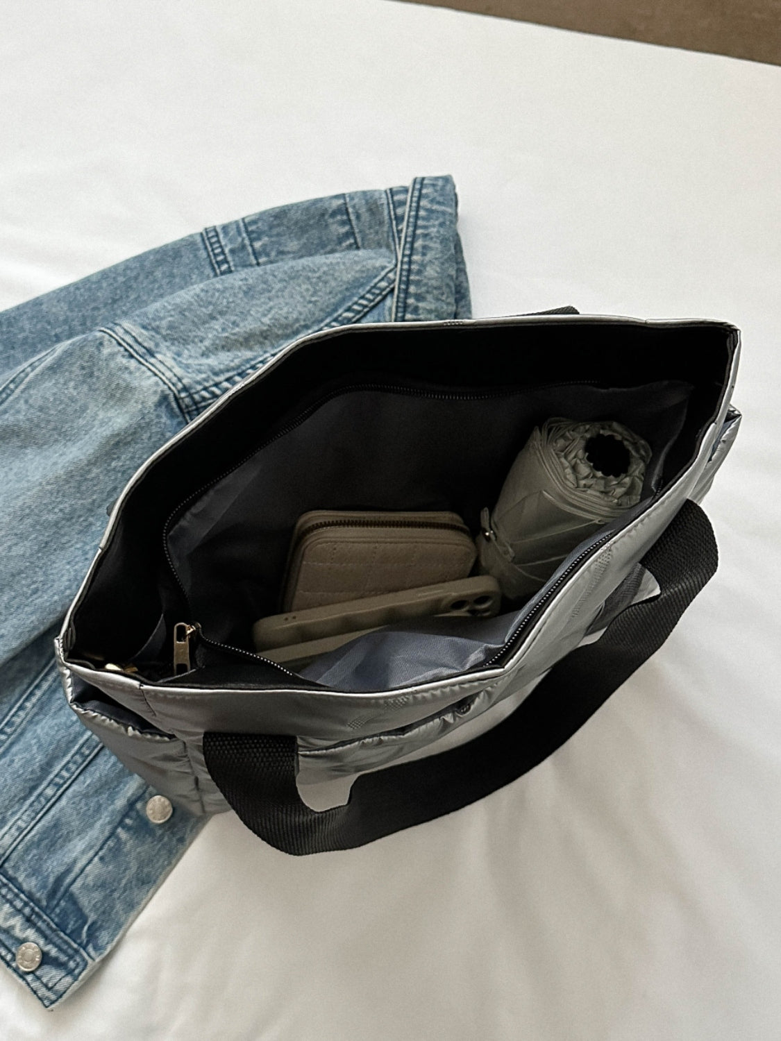 Inside view of the solid color tote bag with side pockets, showcasing organization space and contents.