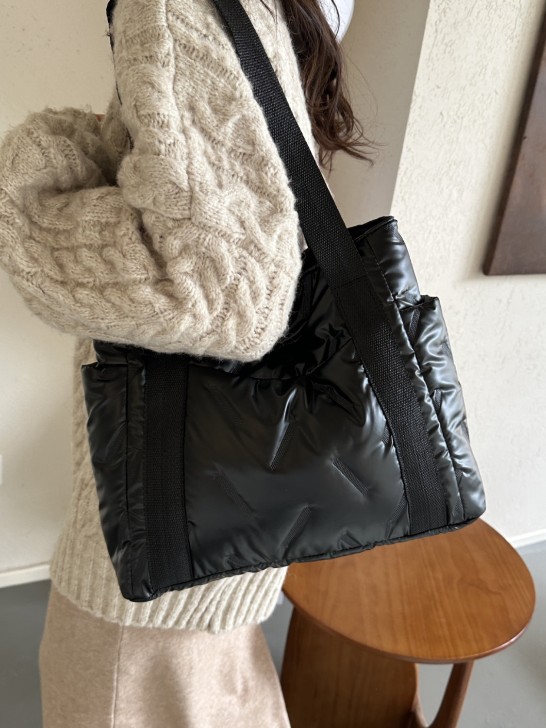 Solid color large tote bag with side pockets in black, made of polyester, styled with a cozy sweater.